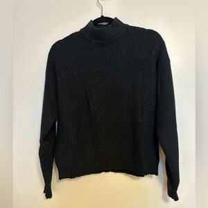 Mockneck black ribbed sweater.